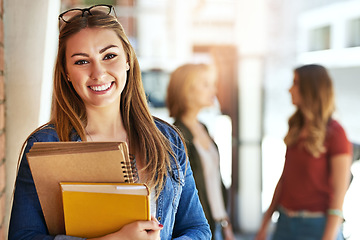 Image showing Portrait, books and flare with a student woman on campus at university for education or learning. Smile, study and college with a happy young female pupil in school for an academic scholarship