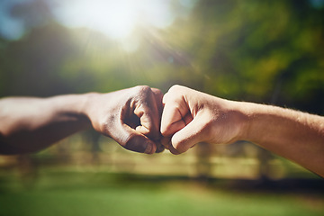 Image showing Hands, fist bump and men in a park with support, solidarity and collaboration on blurred background. Hello, hand and friends greeting outdoor with thank you emoji, sign or respect gesture of unity