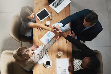 Image showing People, high five and business meeting success at table with documents above for teamwork at office. Top view of group hands in solidarity or motivation for team building, agreement or collaboration