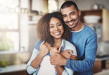 Image showing Love, portrait and happy couple hug in kitchen of home with smile, embrace and healthy relationship. Happiness, man and woman hugging in affection, romance and care in marriage, young people in house
