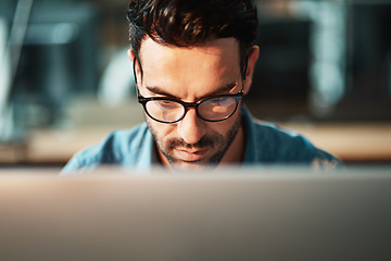 Image showing Serious man, face and glasses at computer in office for planning software update, online research and data analysis. Focused developer, desktop and internet connection for business, website or coding