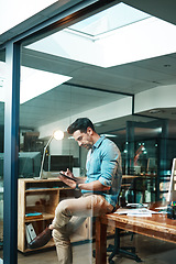 Image showing Business man, tablet and focused in office for planning, data update and internet research at night. Serious male employee, digital technology and strategy for online information, insight and iot app