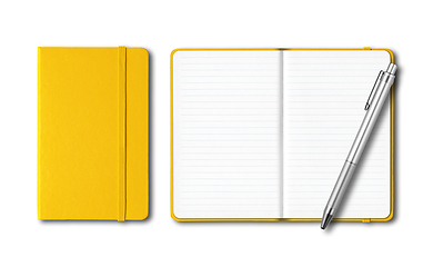 Image showing Yellow closed and open notebooks with a pen isolated on white