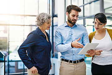 Image showing Business people, tablet and meeting for idea, collaboration or planning together at the office. Group of employee workers working on technology in teamwork for research, project plan or networking