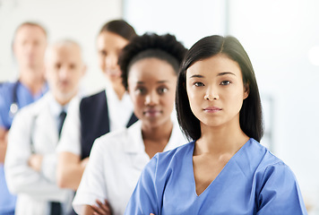 Image showing Teamwork, portrait of doctors and nurses in hospital, support and team work in healthcare. Health, diversity and medicine, serious woman doctor and group of medical employees standing in row together