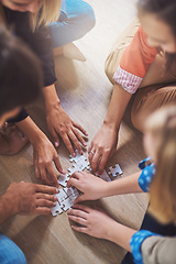 Image showing Top view, people and hands with puzzle for teamwork, solution and problem solving for innovation. Closeup, team building and planning jigsaw for integration, collaboration and synergy for cooperation
