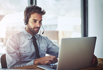 Image showing Man, call center and listen with laptop in office, help desk or talking for telemarketing job. Consultant, agent and crm with customer service, tech support and telecom with headphones, mic and sales