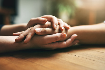 Image showing Holding hands, counseling and support of friends, care and empathy together on table after cancer. Kindness, love and women hold hand for hope, trust or prayer, comfort or compassion, help or unity.