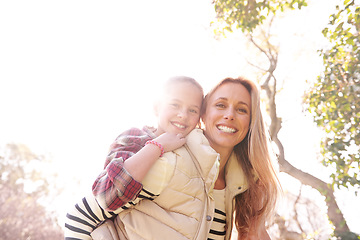 Image showing Love, portrait and mother and child piggyback in a park, bond and having fun outdoor. Happy, face and parent with girl in nature hug, smile and enjoying vacation, weekend or holiday in a forest