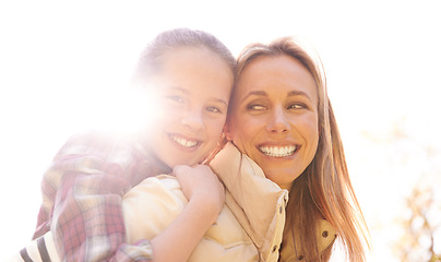 Image showing Portrait, love and piggyback by girl and mother outdoors for bonding, free and having fun in nature. Happy, face and child with parent in a park, hug and sharing cute family moment while walking