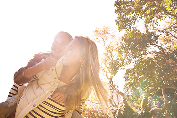 Image showing Love, piggyback and mother with girl child in a park happy, hug and bonding outdoor together. Smile, parent and family embrace in nature, laughing and having fun while walking and enjoying a holiday