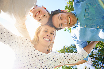 Image showing Face portrait, outdoor circle and happy family hug, love and solidarity of kid, mom and dad bonding in park, forest or woods. Nature freedom, sky and below view of people smile for natural sunshine