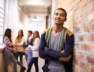 Image showing University, education and portrait of man with crossed arms ready for college, class and learning. Scholarship, happy and face of male student in hallway with friends for school, academy and campus