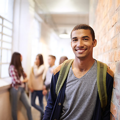 Image showing University, education and portrait of man at college ready for studying, class and learning. Scholarship, knowledge and face of male student in hallway with friends for school, academy and campus