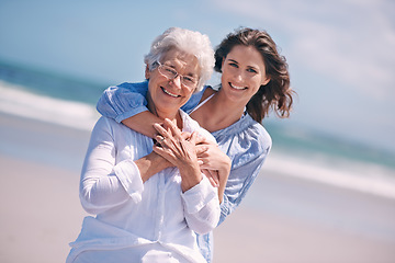 Image showing Portrait, young woman and hug her senior mother or smile or on the beach and together outdoors. Senior citizen, happy family and embracing with adult daughter or peace or freedom at sea for travel