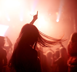 Image showing Dancing, club and back of woman at a concert, disco event or psychedelic trance festival. Night, energy and female person doing dance or moving to a song with red light at techno party or show.