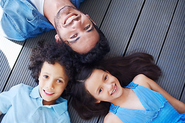 Image showing Floor portrait, relax and happy kids, father or family bonding together, smile and happiness for youth growth. Love, face and top view of solidarity children, dad or group of people lying on ground