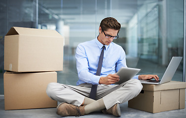 Image showing Tablet, office laptop and man with moving boxes, business data and reading report, statistics analysis or online news. Workplace relocation, cardboard box and male businessman typing research project