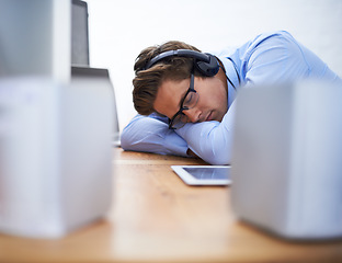 Image showing Office desk, sleep and business man tired after working on project, software system or coding tech, script or programming. Programmer burnout, developer fatigue and sleeping person listening to music