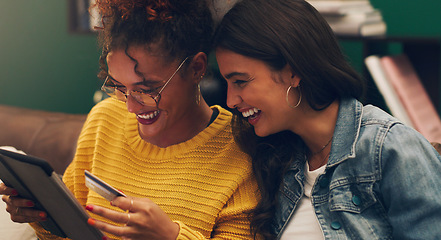 Image showing Girl friends, laugh and credit card with tablet on a living room sofa with online shopping. Student, happiness and young woman together with web purchase and ecommerce payment app on a home lounge