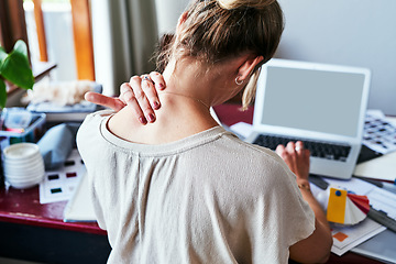 Image showing Neck pain, mockup and laptop screen with back of woman in fashion design studio for website, tired and frustrated. Stress, burnout and mental health with designer for planning, anxiety and tension