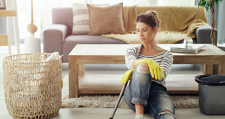 Image showing Tired, home and woman relax, cleaning and chores with gloves, apartment or exhausted in the lounge. Female person, lady or cleaner in the living room, housekeeping and stress with burnout and fatigue