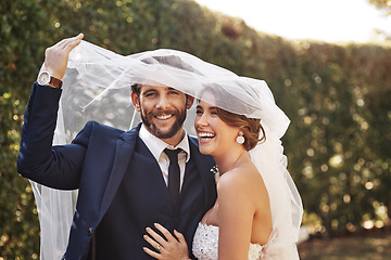 Image showing Wedding, veil and couple with love, marriage and celebration for relationship, loyalty and commitment. Portrait, bride or groom with a smile, married or cover with dress with happiness in a garden