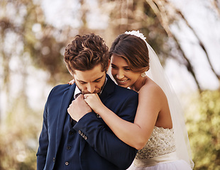 Image showing Wedding, man kiss woman hand and love outdoors in nature background. Commitment or vow, support or celebration and happy or excited young people getting married with kissing gesture for care