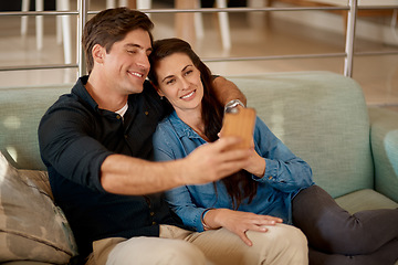 Image showing Young couple, sofa and selfie in home with smile, hug or happiness for love, care and web app. Man, woman and happy for photography, profile picture and social media with bond, relax and lounge couch