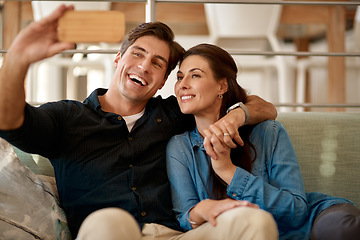 Image showing Couple, sofa and selfie in home for smile, holding hands or pride for love, care or internet app. Man, woman and happy for photography, profile picture or social media for bond, relax or lounge couch