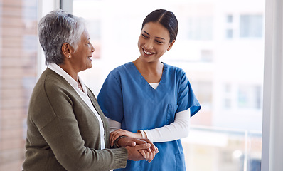 Image showing Support, caregiver with senior woman and holding hands for care indoors. Retirement, consulting and professional female nurse with elderly person smiling together for healthcare at nursing home