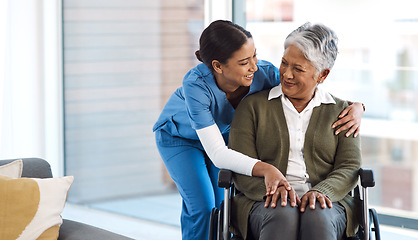 Image showing Hug, nurse with senior woman in wheelchair and talking for support. Happy, smile and communication with female nurse holding disabled senior patients hand for caregiver in nursing home consulting