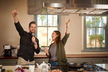 Image showing Food, sing and a funny couple in the kitchen of their home, having fun together while cooking. Karaoke, comic or silly with a man and woman laughing while singing over breakfast in their house