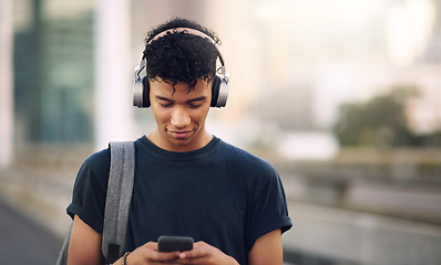 Image showing Phone, music and headphones with a man in the city, streaming an audio subscription service outdoor. Mobile, social media and backpack with a young male tourist outside in an urban town for travel