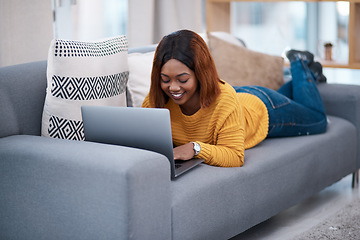 Image showing Black woman, typing on laptop and relax on couch with internet search, blog and communication while at home. African female blogger in apartment, connectivity and writing on pc with browsing online