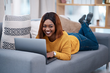 Image showing Black woman with laptop, portrait and relax on sofa, search online for movie and streaming subscription at home. Happy African female person in apartment, connectivity and watching on pc with web