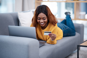 Image showing Black woman, laptop and credit card with online shopping, e commerce with payment on store website and relax on sofa. Happy African female customer, bank app and finance with internet banking at home