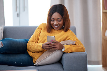 Image showing Black woman with smartphone, chat on social media and relax at home, smile with online communication. African female person, mobile app with text message or post update with connectivity in apartment