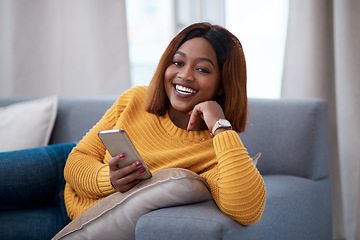 Image showing Black woman using phone, chat on social media and laughing, relax at home with smile in portrait. African female person, app with text and funny meme with connectivity and communication in apartment