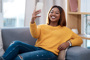 Image showing Black woman, happy in selfie and relax on couch in lounge, lifestyle influencer at home and social media post. African female content creator in apartment, smile in picture and communication on app