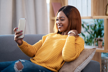 Image showing Black woman in her home, selfie and relax on couch in living room, lifestyle influencer and social media post. African female content creator in apartment, smile in picture and communication with app