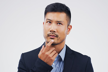 Image showing Thinking, planning and an Asian businessman with ideas isolated on a white background in a studio. Idea, business and a corporate employee with a choice, decision or remember question on a backdrop