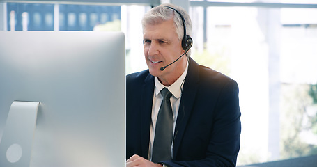 Image showing Video call, computer and a mature business man using a headset in the office during an online meeting. Desktop, smile communication with a senior male manager or CEO in an online training webinar