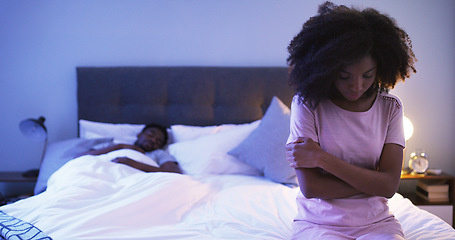 Image showing Black couple, bedroom and sad woman at night thinking of divorce, stress or depression. Man sleeping in home bed with partner upset about fight, marriage and erectile dysfunction or cheating secret