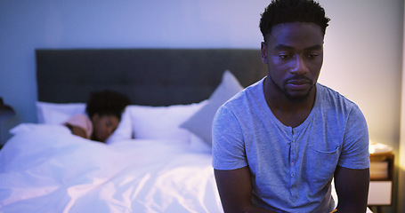 Image showing Black couple, bedroom and man with a problem at night while thinking of divorce, stress or depression. A woman sleeping in bed at home with partner upset about fight, marriage or erectile dysfunction