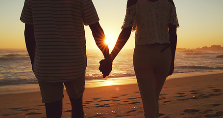 Image showing Couple holding hands, beach at sunset and ocean with back view, vacation and travel with man and woman outdoor. Love, romance and trust with people in commitment, tropical holiday and sea waves