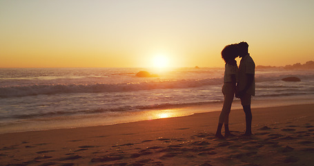 Image showing Sunset, kiss and silhouette of couple at the beach for bonding, date or holiday in Bali. Care, dark and a man and woman kissing at the ocean together for love, romance or vacation freedom by the sea