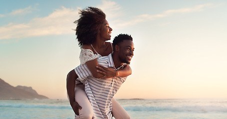 Image showing Black couple, piggyback on beach and travel with hug, love and freedom outdoor, sea view and mockup space. Nature, adventure and vacation, man and woman bonding, happiness and trust in relationship