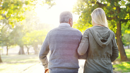 Image showing Senior man, daughter and walking outdoor at a park with love, care and support for health and wellness. A elderly male and woman of family in nature for a walk, quality time and healthy retirement