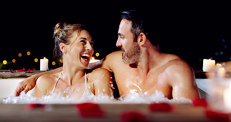 Image showing Spa, love and couple in a jacuzzi happy, smile and relax one date night at a wellness resort. Zen, hot tub and man with woman laughing, peace and enjoying a romantic vacation, holiday or anniversary